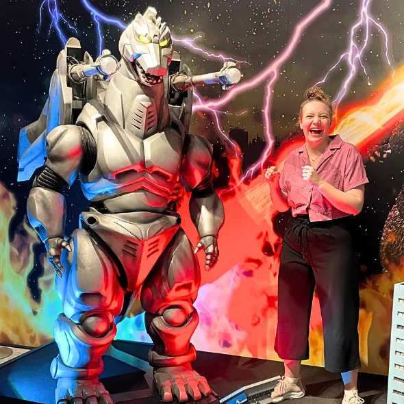 A woman posing with MechaGodzilla at the Godzilla Museum on Awaji Island, Japan