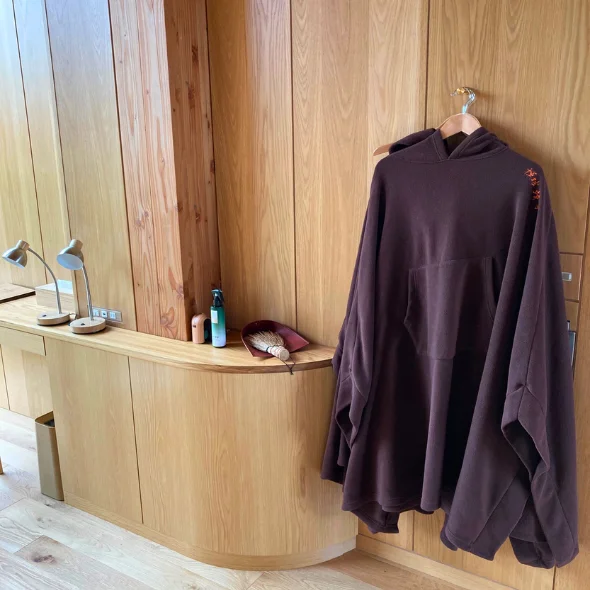 The wearable blanket or a snuggie displayed in the guest room.