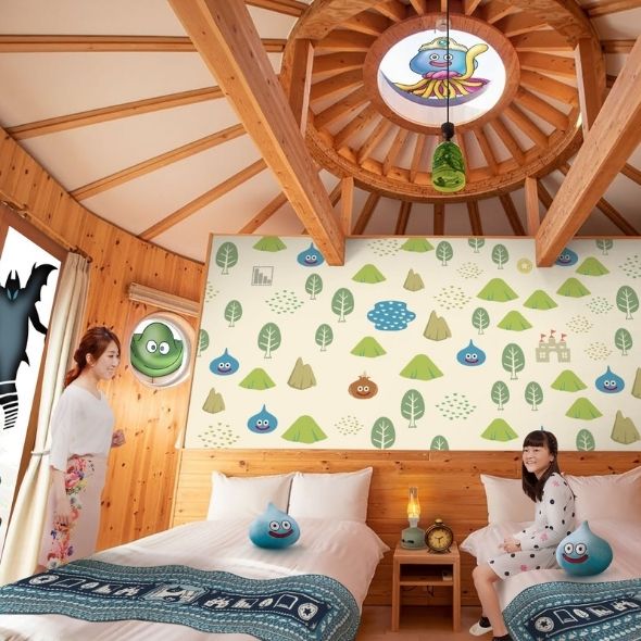 Dragon Quest Slime Cocoon bedroom with two beds, themed wallpaper, and guests at Grand Chariot Awaji Island