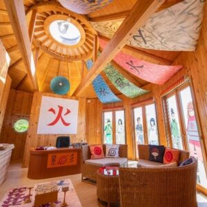 Naruto Hokage Villa lounge with sofa, themed pillows, round coffee table, large windows and terrace access at Grand Chariot Awaji Island
