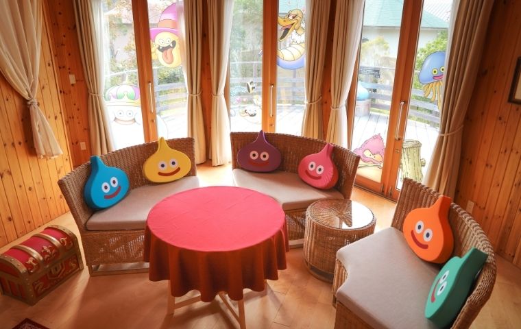 Dragon Quest Slime Cocoon sofa with slime pillows, large window with slime designs and terrace view at Grand Chariot Awaji Island