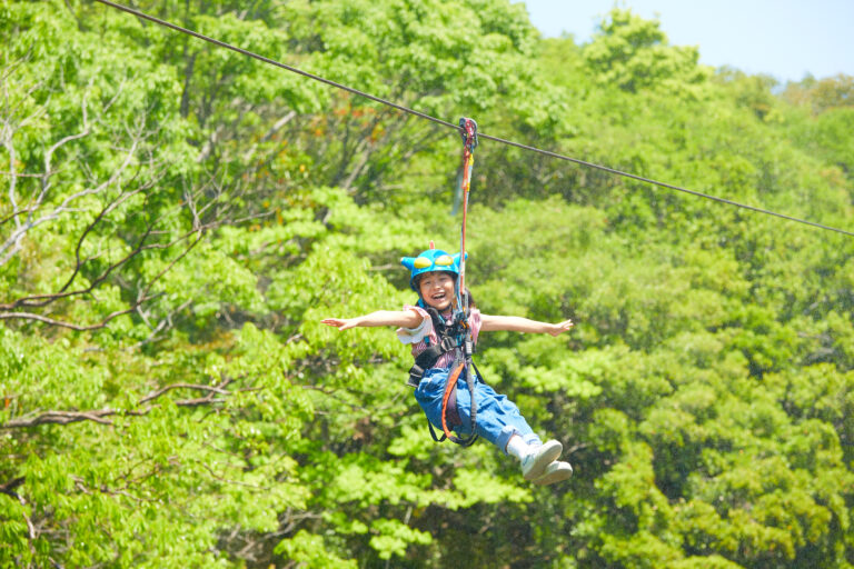 Child flying on Action Mask zipline at Crayon Shinchan Adventure Park in Nijigen no Mori Awaji Island