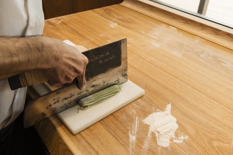 Cutting of soba with a big knife on a board
