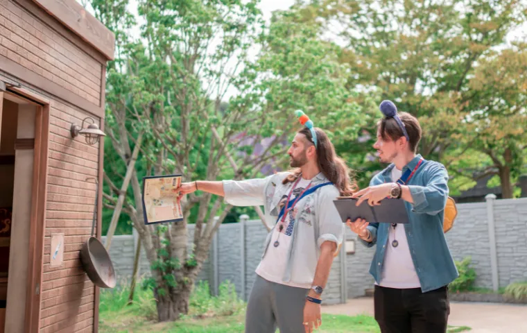 Two men wearing funny headbands starting adventure in Dragon Quest Island at Nijigen no Mori Awaji Island