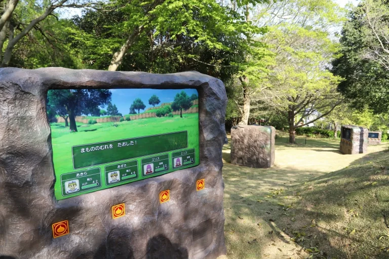 RPG quest display screen with instructions in Dragon Quest Island at Nijigen no Mori Awaji Island