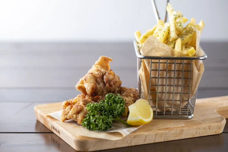 Japanese karaage fried chicken with fries and lemon on wooden plate at Nijigen no Mori Awaji Island