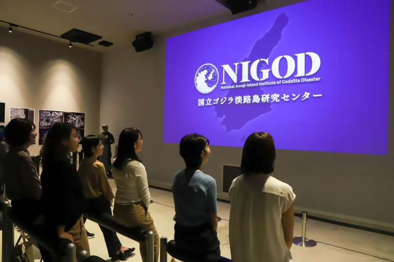 Visitors watching a Godzilla disaster briefing film at the Godzilla Museum in Nijigen no Mori on Awaji Island, Japan