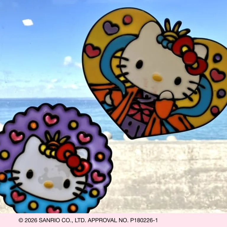 Hello Kitty vinyl stickers on a window with ocean view in the background