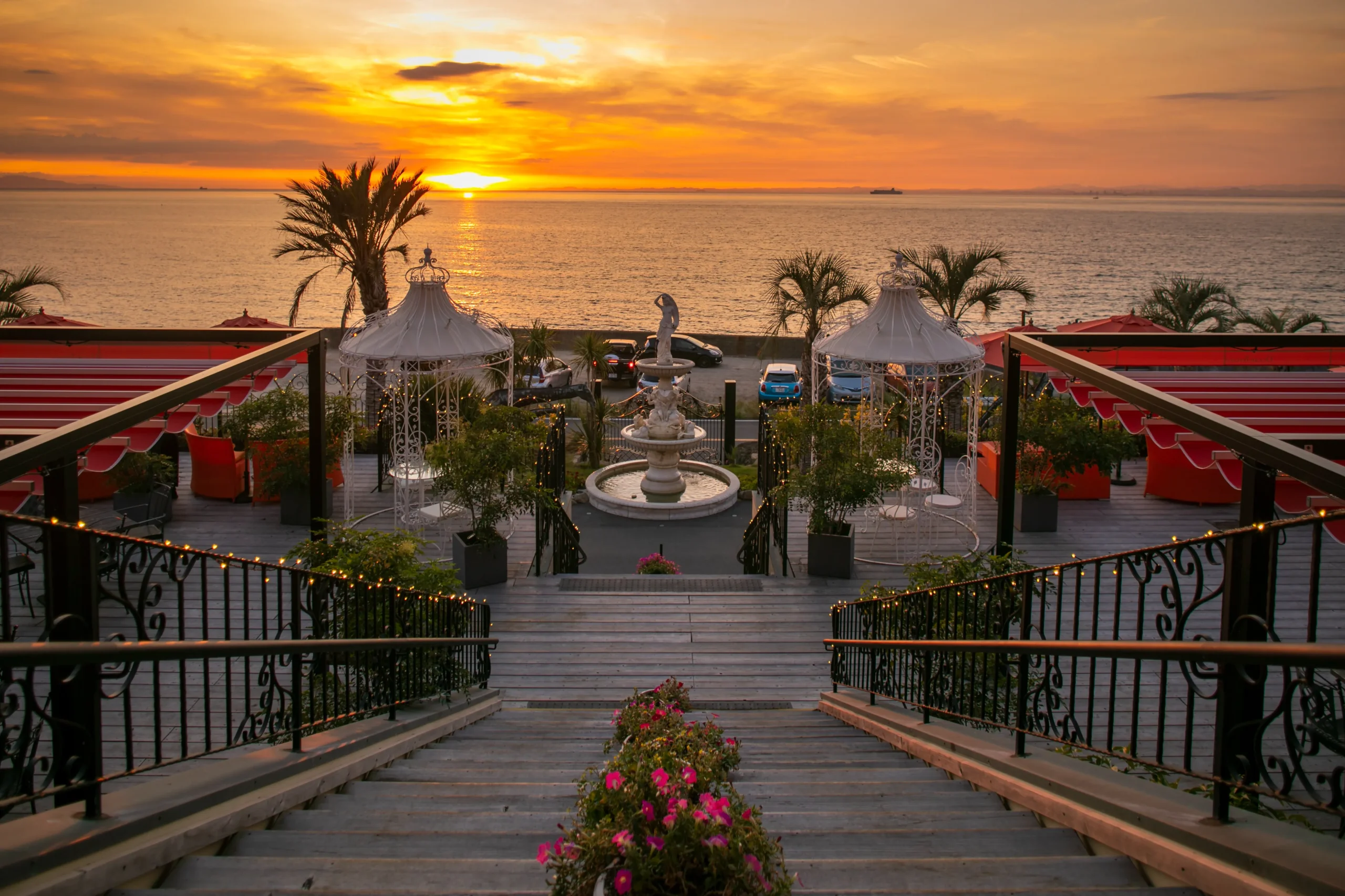 A breathtaking golden sunset over the sea, viewed from the scenic outdoor terrace at Ocean Terrace on Awaji Island.
